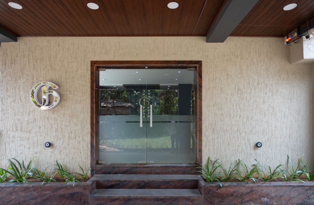 Curated interior shadowy hallway with natural light illuminating polished travertine stone walls at Hotel Grand Blue Star
